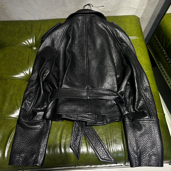 Black leather jacket on a green couch